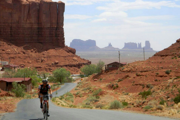 Cycling past Monument Valley on the North American Epic